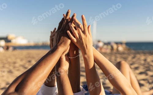 Preview: Hands of diverse people touching each other on the beach