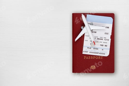 Preview: Passport, boarding pass and toy airplane on table top view