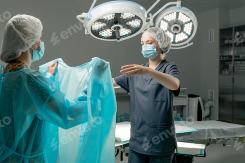 Preview: in a modern clinic in a bright spacious operating room, the doctor, the surgeon, with sterile hands
