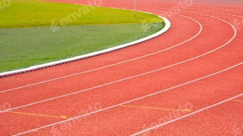 Preview: Curve lines pattern background of red synthetic running tracks and green field in athletic stadium