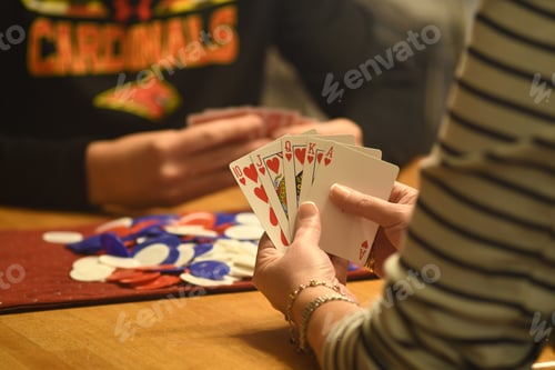Preview: Close-up of flash royal in woman's hands during a poker game
