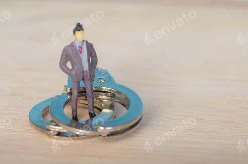 Preview: Businessman in Handcuffs: Symbol of Corporate Misconduct and White-Collar Crime