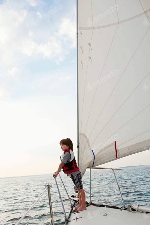 Preview: Young adventurer at the helm of a sailing boat.
