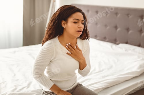 Preview: African American woman coughing, suffering from sore throat
