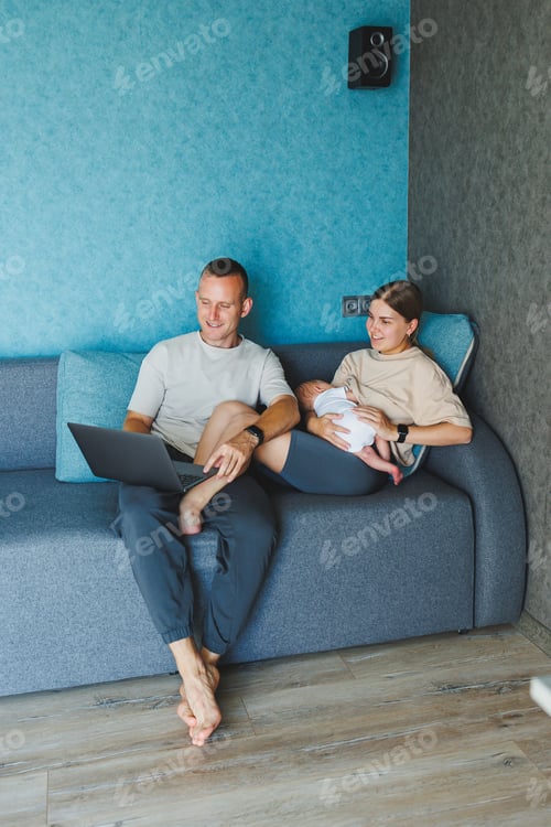 Preview: Happy family mom, dad and cute baby son having fun using laptop at home. Young parents