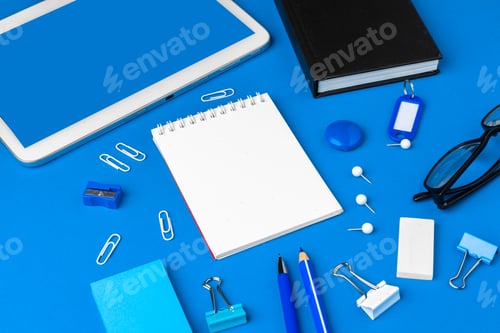 Preview: Flat lay, top view of blue office table desk. Workspace with blank note book, office supplies
