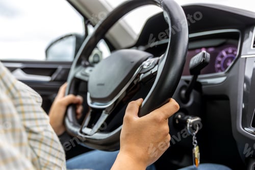 Preview: Driver at steering wheel. Hands on car wheel. Modern vehicle interior