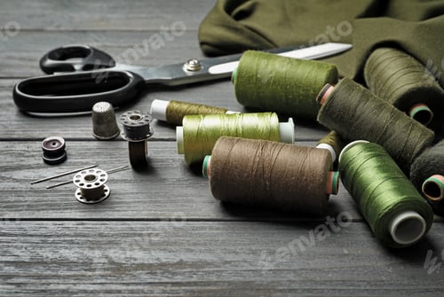 Preview: Bobbins with threads on table. Tailoring accessories