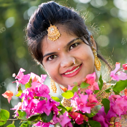 Preview: Beautiful Indian bride in traditional wedding dress at outdoor.