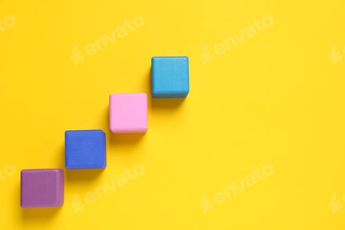 Preview: Many colorful cubes on yellow background, flat lay and space for text. Management concept