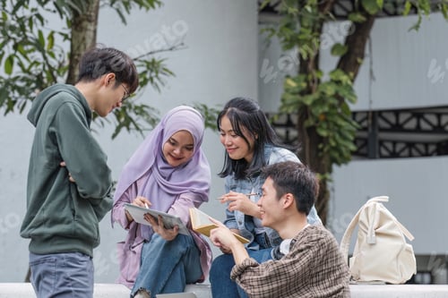 Preview: Group of Asian college student reading books and tutoring special class for exam on grass field at