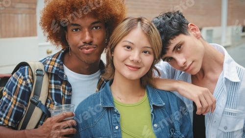 Preview: Group of friends, two guys and girl, look at the camera with smile