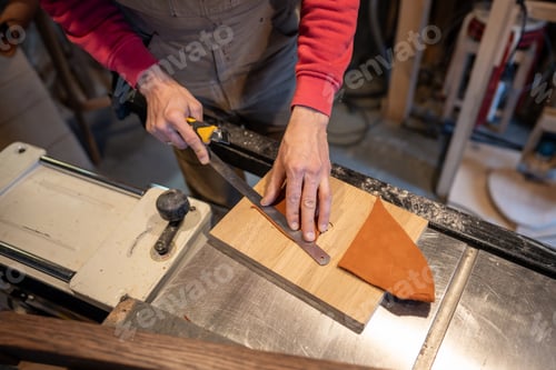 Preview: Male hands cutting leather skin. Master shoemaker cobbler professional working with knife.