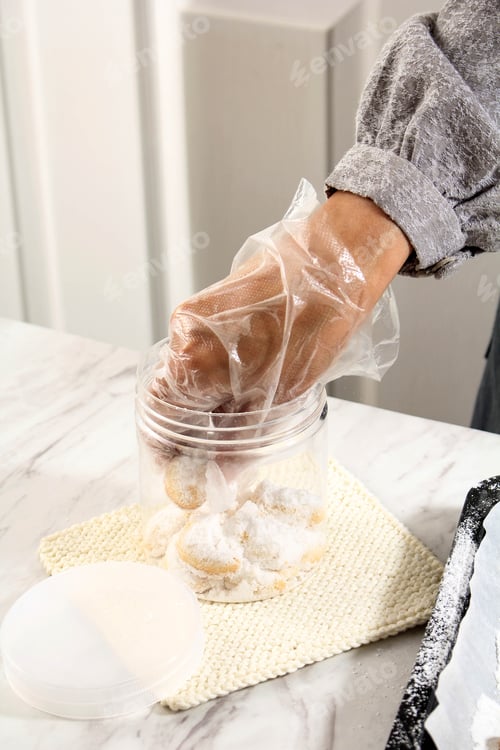Preview: Asian Female Hand Put Kue Kering (Cookies) on the Clear Box