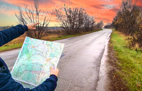 Preview: A man looks at a map on the road. Selective focus.