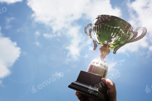 Preview: Holding up a trophy cup as a winner