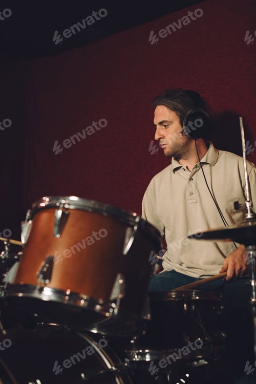 Preview: Man Plays Drums with Headphones in Recording Studio