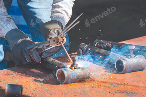 Preview: Welder hand welding nut and bolts on steel pipe for apply to metal joint in construction site area