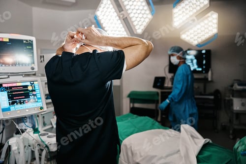 Preview: Surgery, healthcare or doctor with mask in operating room, theater or trauma unit for anatomy emerg