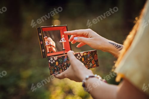 Preview: Childhood Trauma In Adults. Outdoor portrait of Woman holding a music box in her hands
