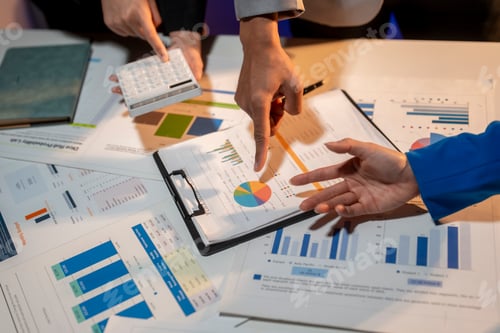 Preview: A group of people are looking at a table full of graphs and charts