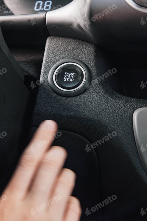 Preview: Hand pressing stop button on car steering wheel, closeup view