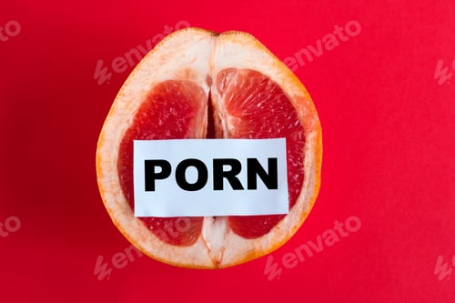 Grapefruit Half with Obscenity Message on Red Background