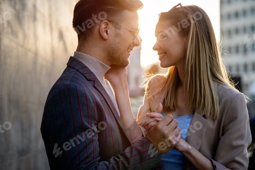 Preview: Happy successful business couple in love having fun together in urban background.
