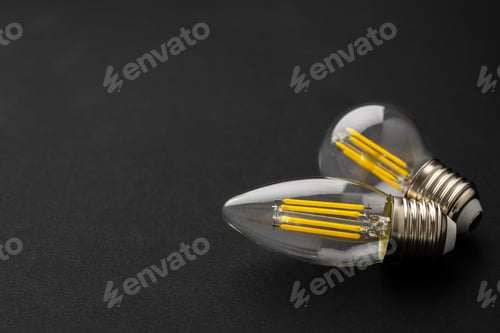 Preview: Compact light bulb isolated on black background