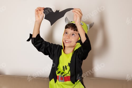 Preview: Boy wearing monster costume holding bat for halloween party