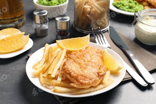Preview: Plate with British traditional fish and potato chips on grey table