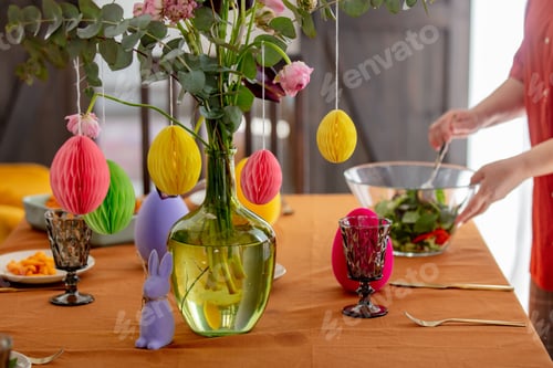 Preview: woman sets the Easter table. for dinner. True lifestyle