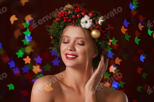 Preview: Beautiful young woman wearing Christmas wreath on blurred background. Bokeh effect