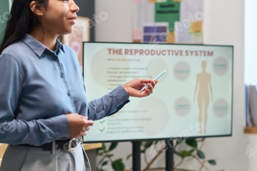Preview: Young Adult Hispanic Woman Explaining Reproductive System in Classroom Setting