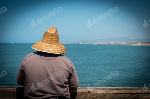 Preview: Man with Straw Hat Fishing on the Pier