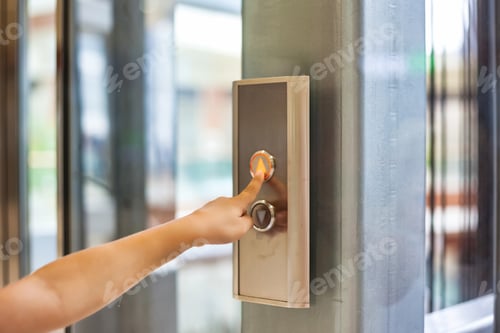 Preview: A hand reaches towards a shiny elevator button in a sleek manner