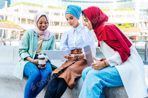 Preview: Beautiful muslim girl wearing hijab bonding outdoors