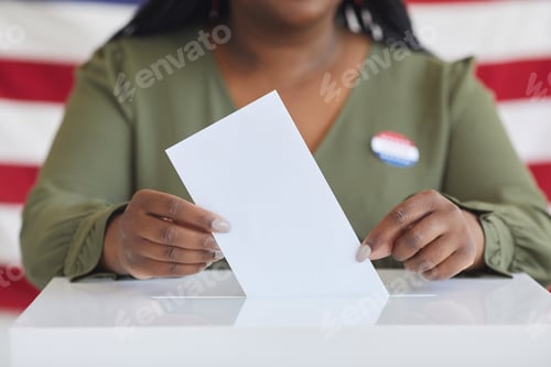 Preview: African-American Woman Putting Vote in Ballot Box Close up