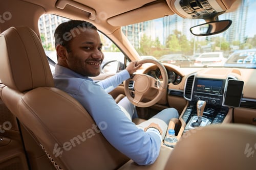 Preview: Pleased motorist sitting in auto during traffic jam on road