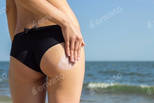 Preview: Suntan Lotion Woman Applying Sunscreen Solar Cream. Beautiful cute girl