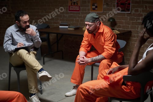 Preview: Caucasian Man in Prison Uniform Attending Group Therapy Session