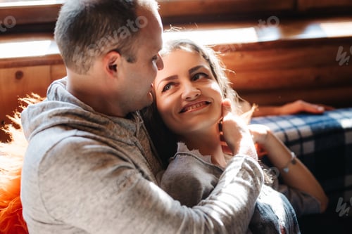 Preview: Romantic Adult Couple Embracing Indoors Near a Window