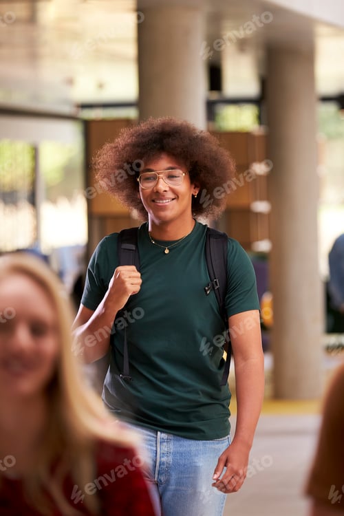 Preview: Smiling Male Student In Busy University Or College Building