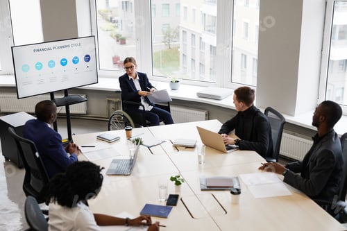 Preview: Female Leader using Wheelchair in Business Meeting