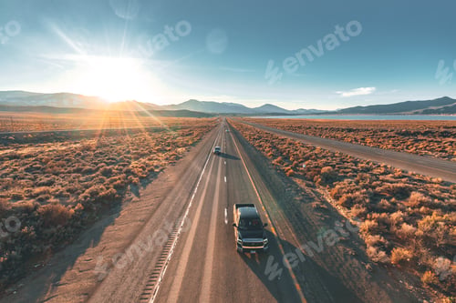 Preview: Drone shot of cars driving on the highway in the sunset.