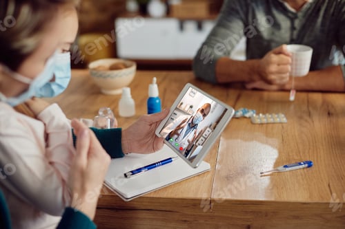 Preview: Close-up of family having video call with their doctor at home due to COVID-19 pandemic.