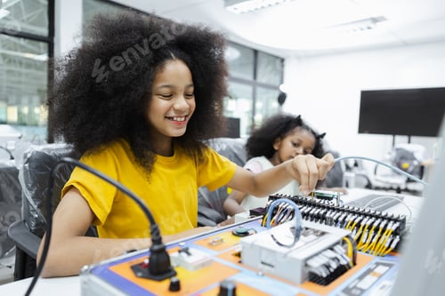 Preview: children girl with afro hairstyle education electronic on table at class room. learning innovation
