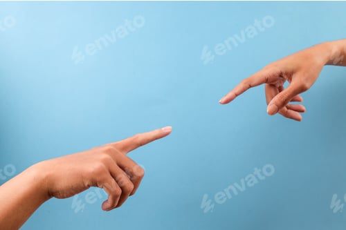Preview: Two Hands Pointing Fingers At Each Other Isolated On Blue Background