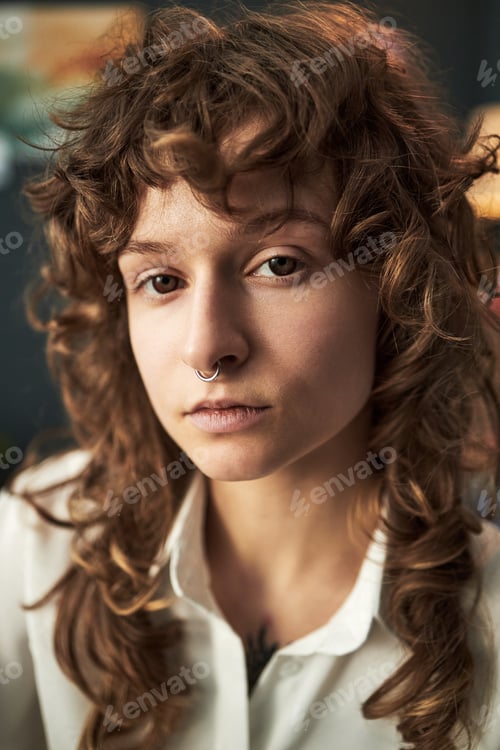 Preview: Portrait of Caucasian Young Adult Woman Staring Seriously Indoors