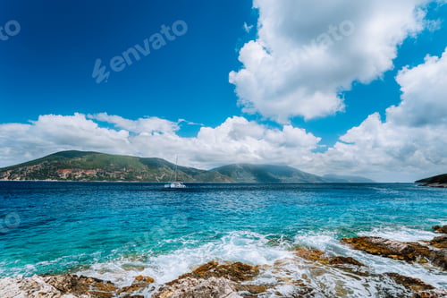 Preview: White yacht drift in middle of open crystal clear emerald green sea water near Fiskardo town. Ithaki